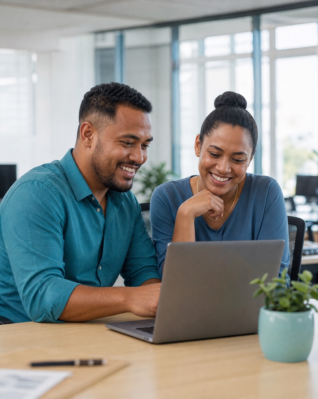 A Fijian hiring team reviewing applicants together on a laptop